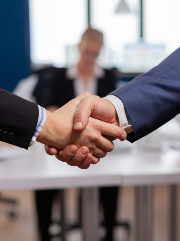 Satisfied businessman company employer wearing suit handshake new employee get hired at job interview, Man hr manager employ successful candidate shake hand at business meeting, placement concept